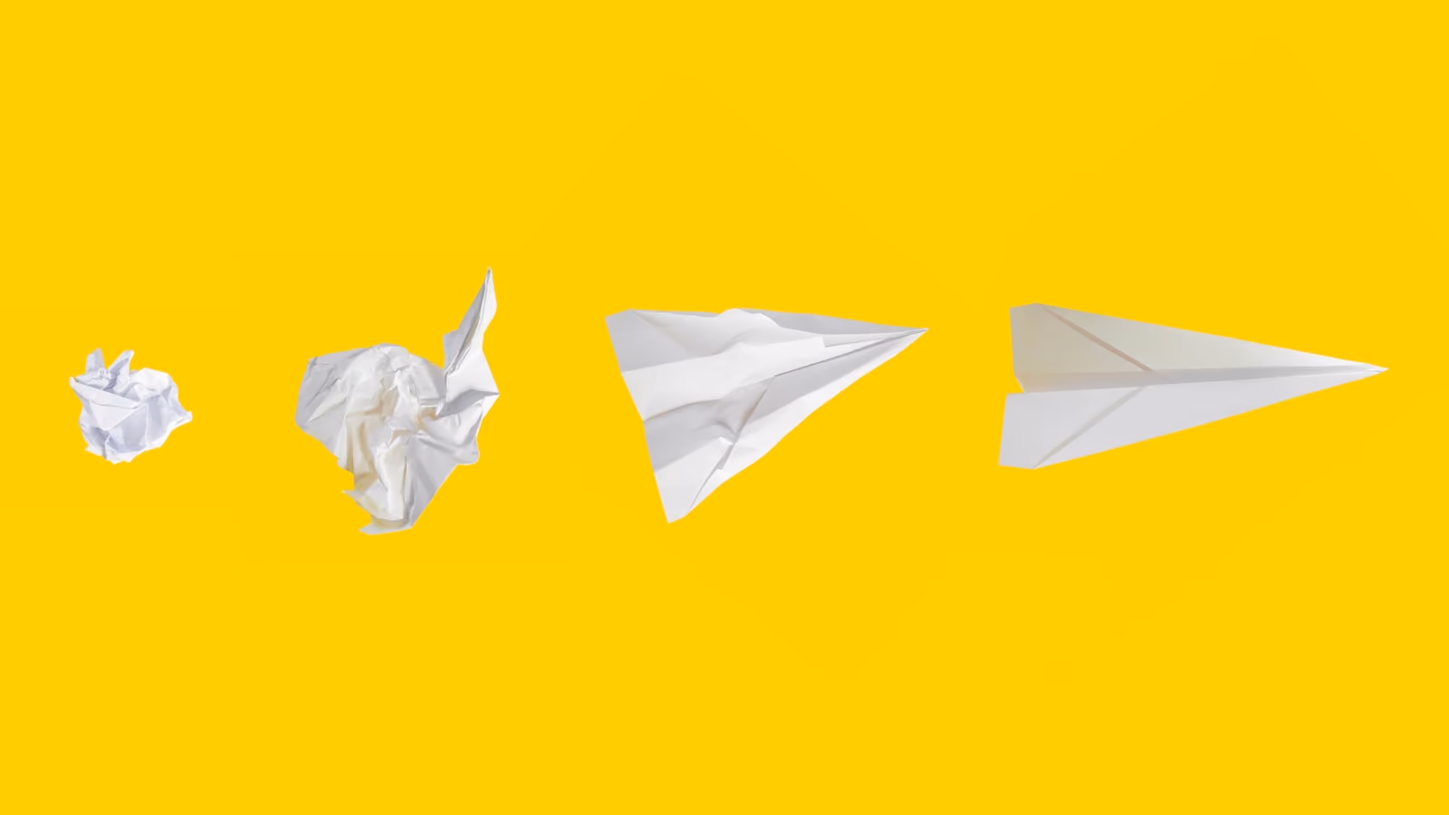 A crumpled sheet of paper and three paper planes on a yellow background